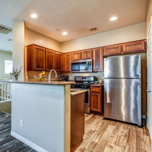 a kitchen with stainless steel appliances and wooden cabinets