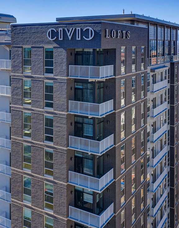 A tall building with the words CIVIC LOFTS on the top.