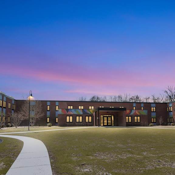 A long building with a walkway in front of it.