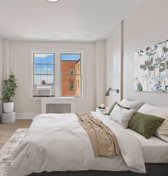 a bedroom with a bed and a large window