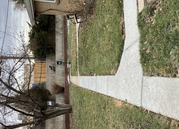 an aerial view of the side of a building and a sidewalk