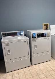 A row of white appliances are lined up in a room.