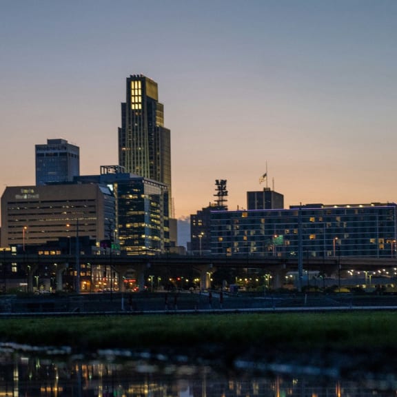 the city at sunset reflected in the water of a river