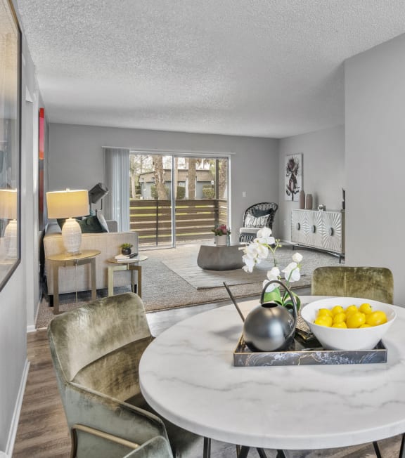 a living room and dining room with a table and chairs and a kitchen
