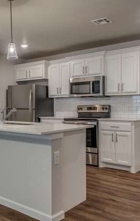 a kitchen with white cabinets and a white counter top