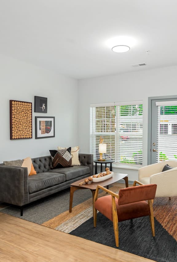 a living room with a couch and a chair and a table