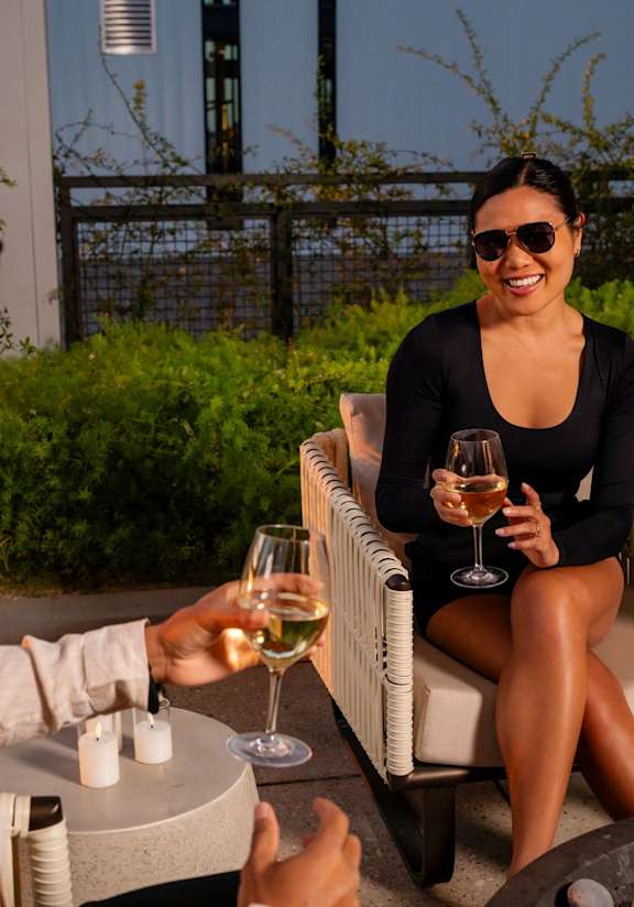 a woman drinking a glass of wine