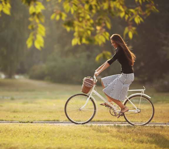 A woman riding a bike in a field.at Parkview Apartments, Memphis, 38104