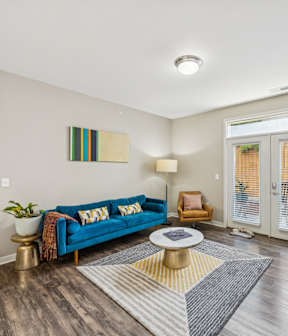 A living room with a blue couch and a television.