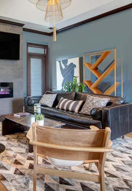 A living room with a fireplace and a television mounted on the wall.