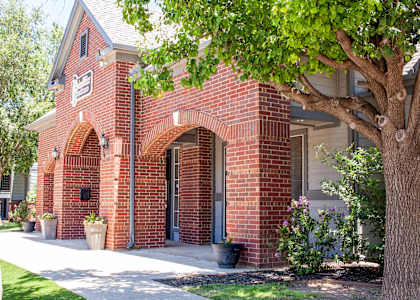 a brick building with a tree in front of it