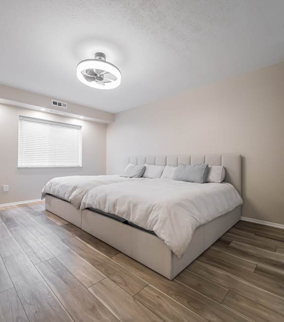 A bedroom with a large bed and a window.