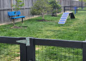 Thumbnail 31 of 34 - a backyard with a bench and a trampoline