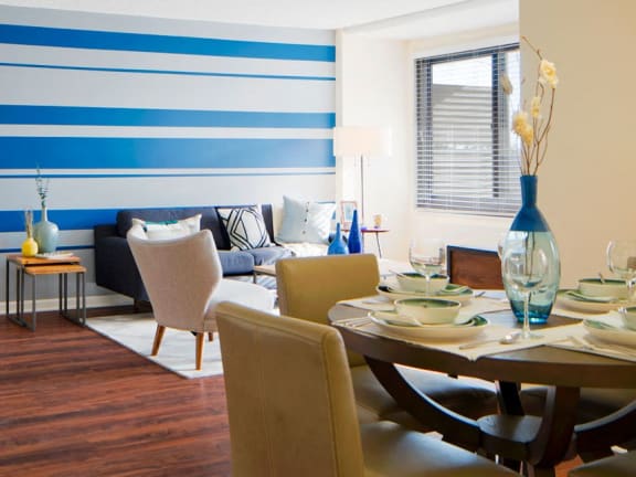 a living room with a blue and white striped accent wall