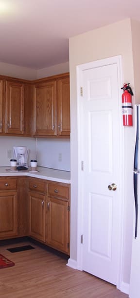 a kitchen with white cabinets and a black stove and refrigerator