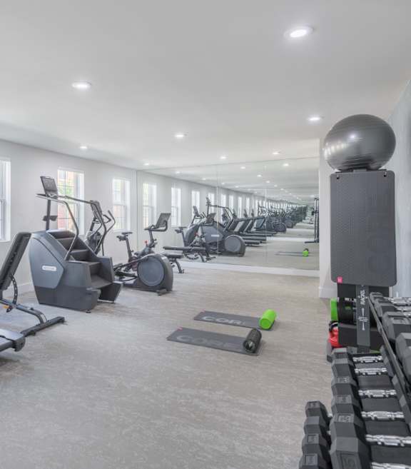 A spacious home gym with a variety of exercise equipment.