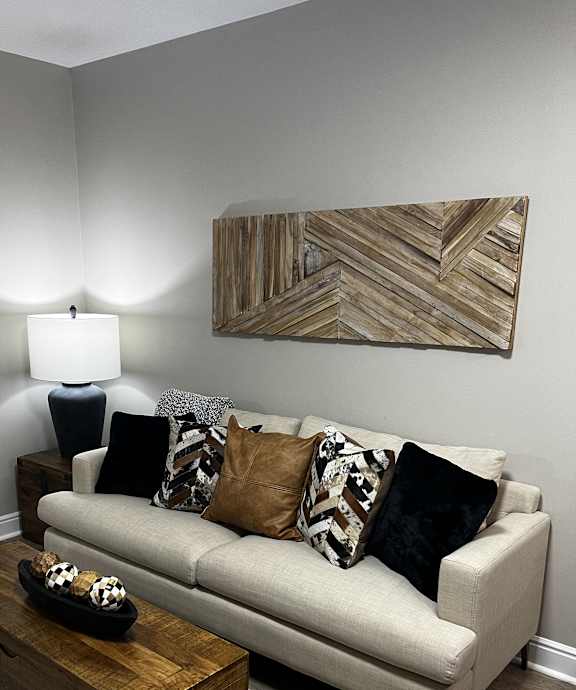 a living room with a couch and a table and a mirror