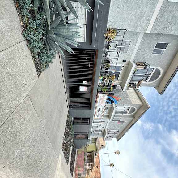 a view of a gated garage and apartment building at The Marq Apartments LLC, California, 90042