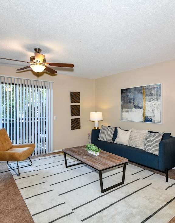 A living room with a couch, coffee table, and a chair