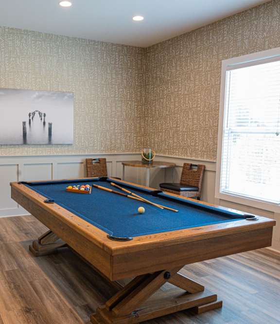 a game room with a pool table and a painting