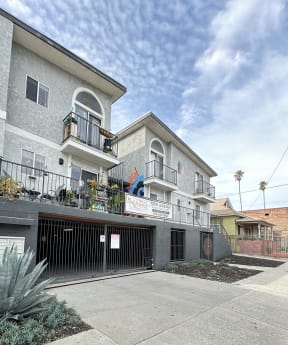 a view of a gated garage and apartment building at The Marq Apartments LLC, California, 90042