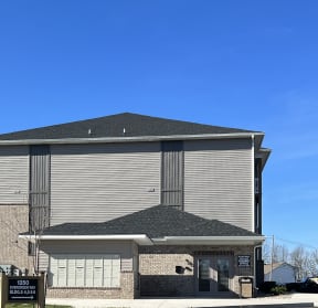 a birds eye view of a building with a roof and a blue sky