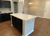 Thumbnail 16 of 23 - A modern kitchen with a wooden counter top and a stainless steel range hood.