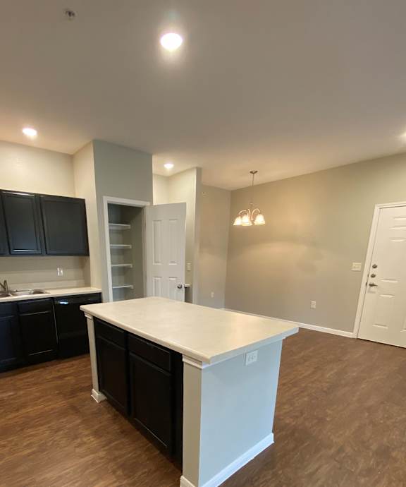 A modern kitchen with a wooden counter top and a stainless steel range hood.