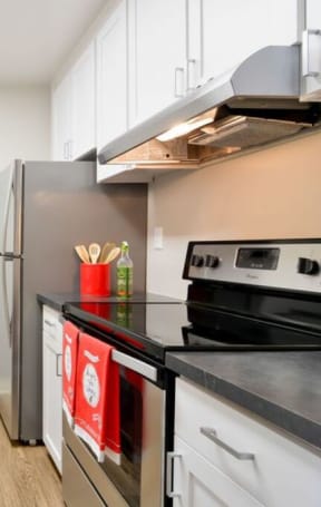 a modern kitchen with stainless steel appliances and white cabinets at Parc Medallion LLC, Union City, CA 94587
