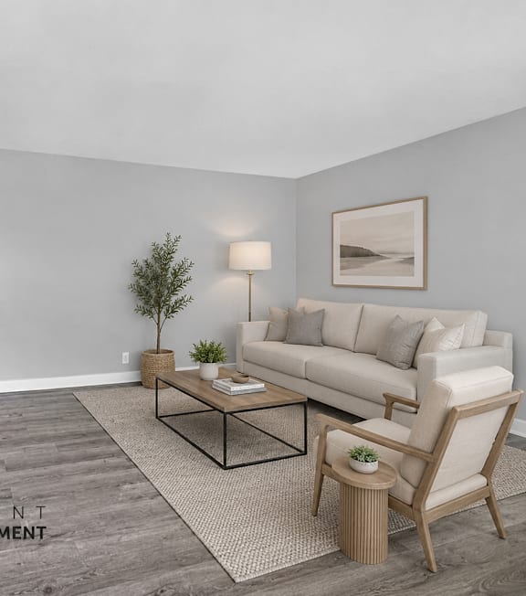 A living room with a couch, chair, and coffee table.