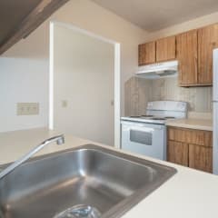 a kitchen with a sink stove and refrigerator