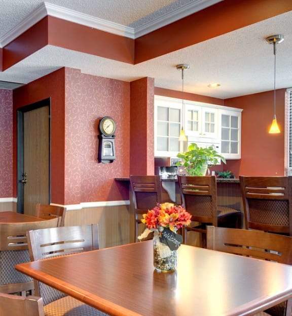 a dining room with a wooden table and chairs  at Mallard Ridge, Maple Grove