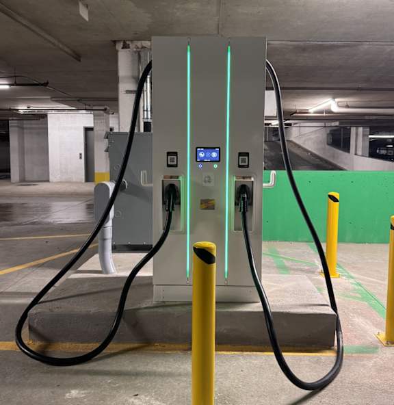 A charging station for electric vehicles is located in a parking garage.