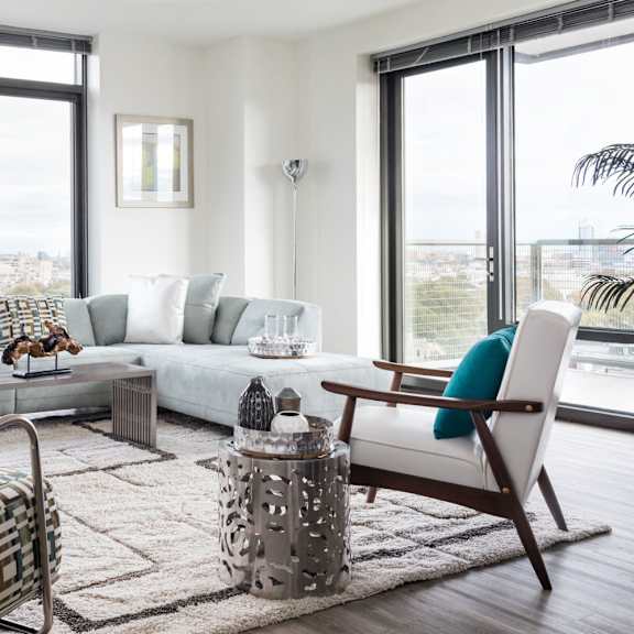 A living room with a large window overlooking the city.