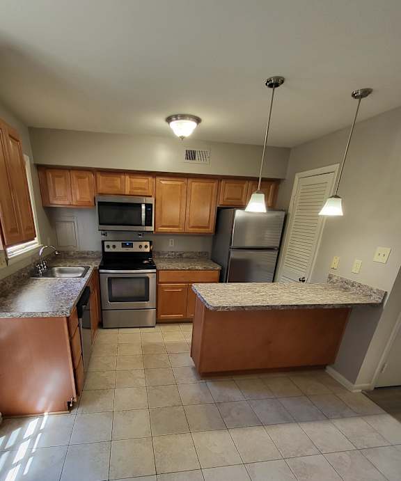 a view of the kitchen from the top of the stairs