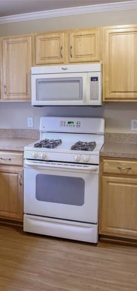 a kitchen with white cabinets and a black stove and refrigerator