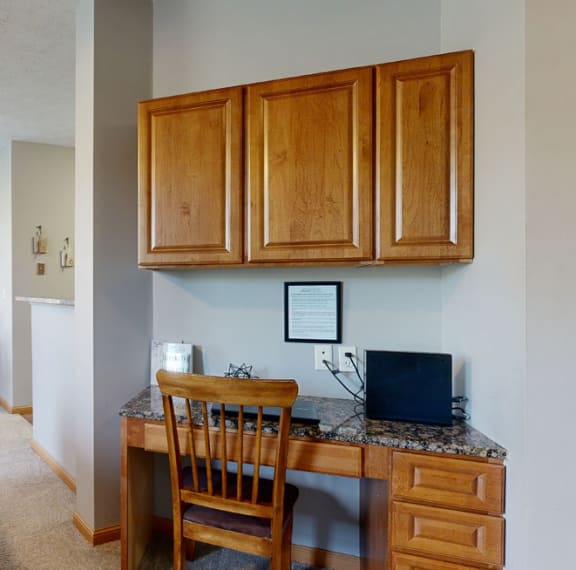 built in desk workspace with dining area in background
