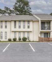 an empty parking lot in front of an apartment building