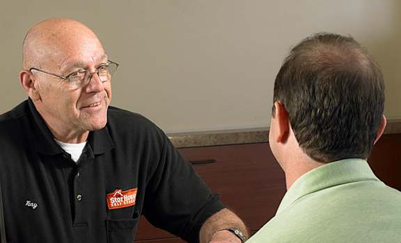 A sign that says "Friendly customer service Exceeds Expectations!" is on an orange background.
