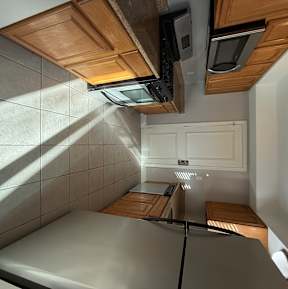 a kitchen with a stove top oven and a sink