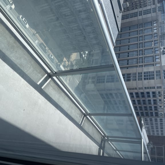 Glass and stainless steel railings on the patios provide minimal obstruction to the outstanding view of the city and plaza below.