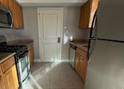 Thumbnail 17 of 18 - a kitchen with a stove top oven and a sink at Hidden Brook Apartment Homes Apartments, New Bedford, 02740