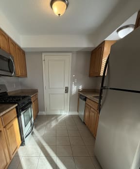 a kitchen with a stove top oven and a sink at Hidden Brook Apartment Homes Apartments, New Bedford, 02740