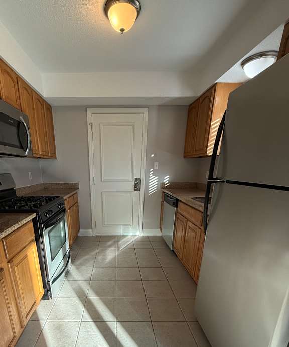 a kitchen with a stove top oven and a sink at Hidden Brook Apartment Homes Apartments, New Bedford, 02740