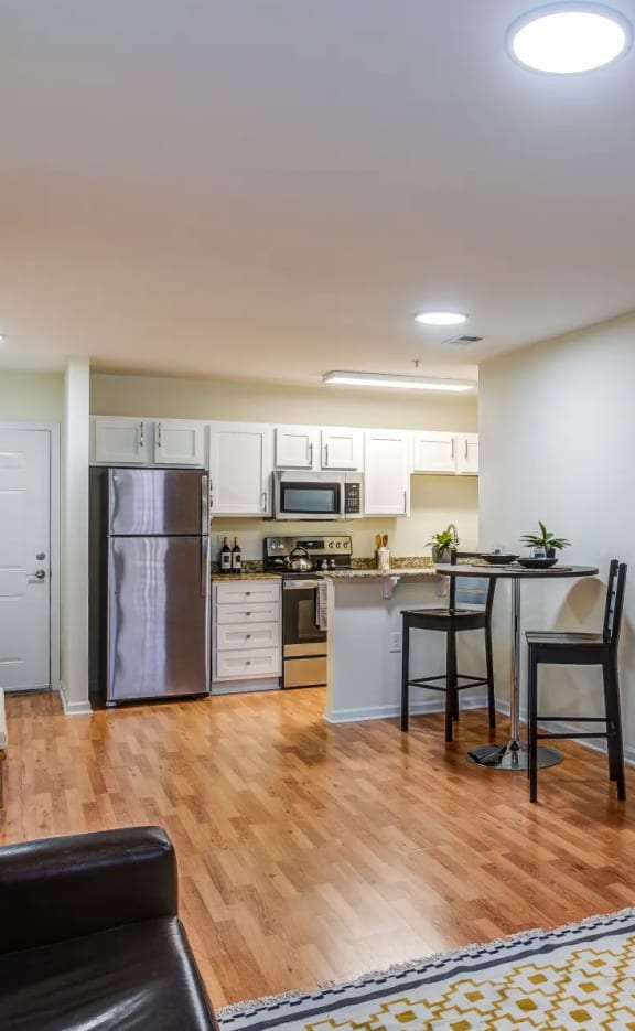 a view of the living room and kitchen of a two-bedroom apartment at Oasis at Twinwood
