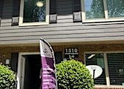 Thumbnail 14 of 17 - A purple umbrella is open on a patio.
