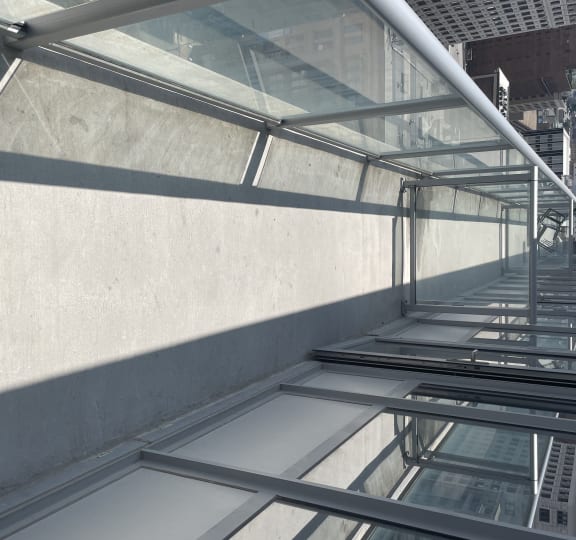 Glass and stainless steel railings on the patios provide a minimally obstruction to  outstanding view of the city and plaza below.