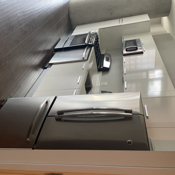 Generous cabinets, granite countertops, and stainless-steel appliances fills the kitchen space.
