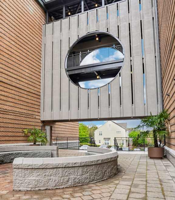 A set of stairs with a metal railing lead up to a balcony.