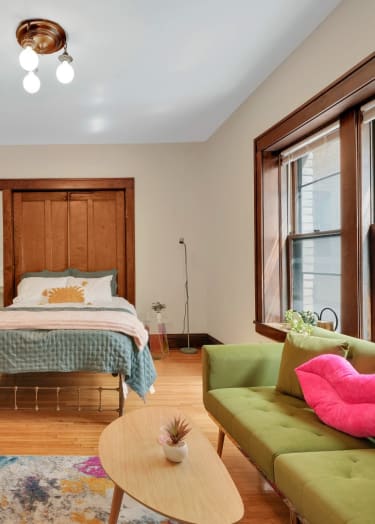 a kitchen with white cabinets and a checkered floor at The Park Apartments in Minneapolis, MN